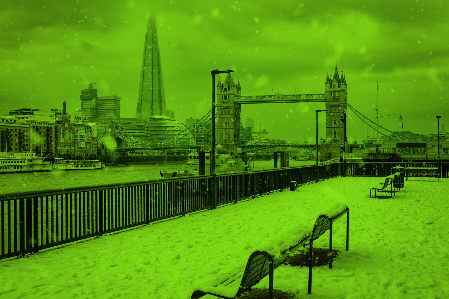 London skyline showing the shard and tower bridge in winter in the snow